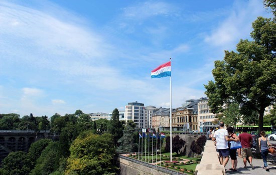 Luxembourgian flag flying over the city