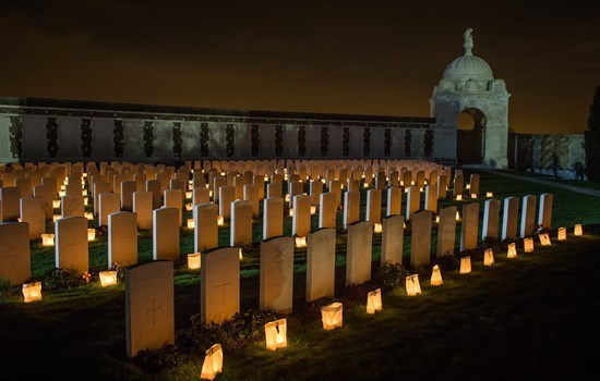 Candles in front of the thombstones of Tyne Cot cemetery, near Ypres, Belgium